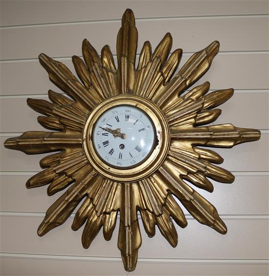 A gilt starburst framed wall timepiece